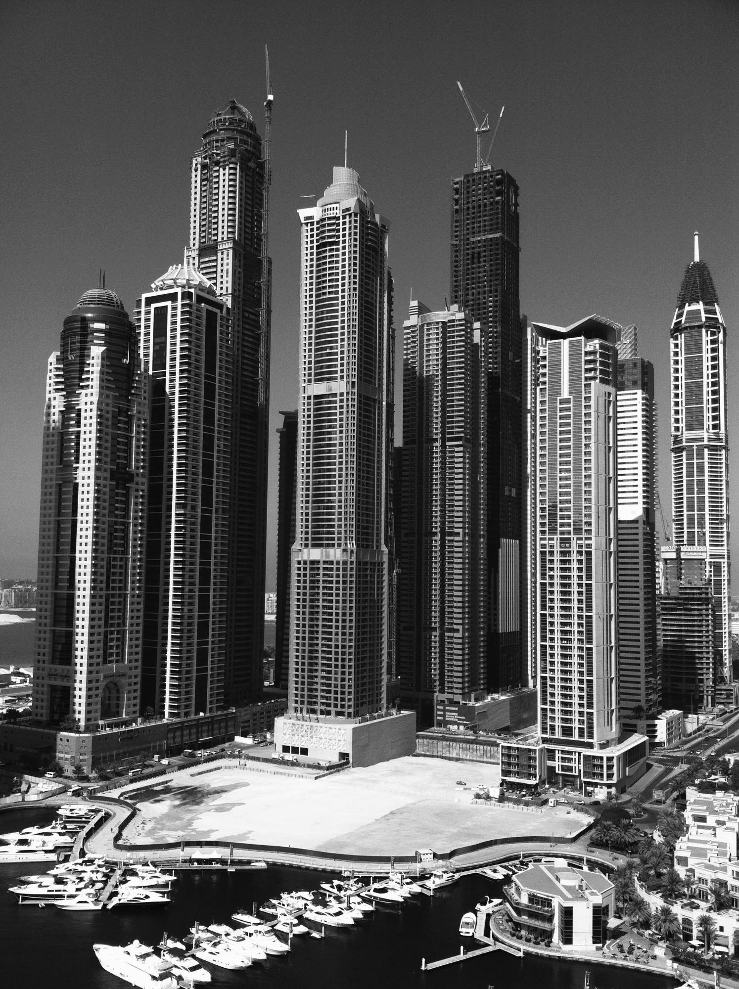 Dubai Marina towers under construction above the yacht harbour